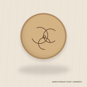 Round ash-coloured wooden plaque engraved with an original triple spiral study
