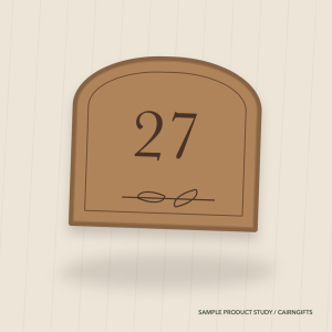 Arched oak-coloured door plaque engraved with the number twenty seven and a leaf border