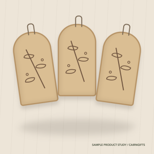 Three pale wooden hanging ornaments engraved with hawthorn leaves and berries